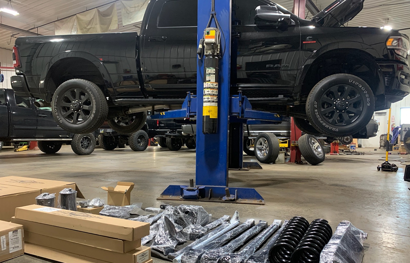 black truck in shop getting worked on