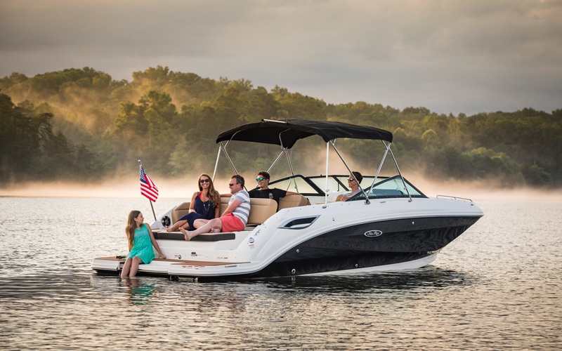 family in a boat out on the lake