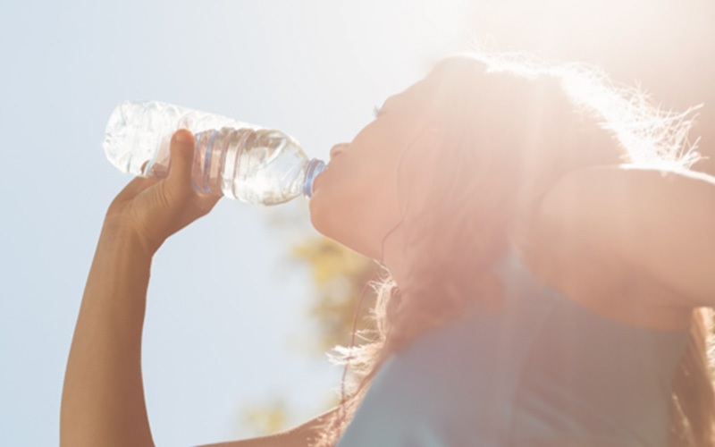 woman drinking a bottle of water