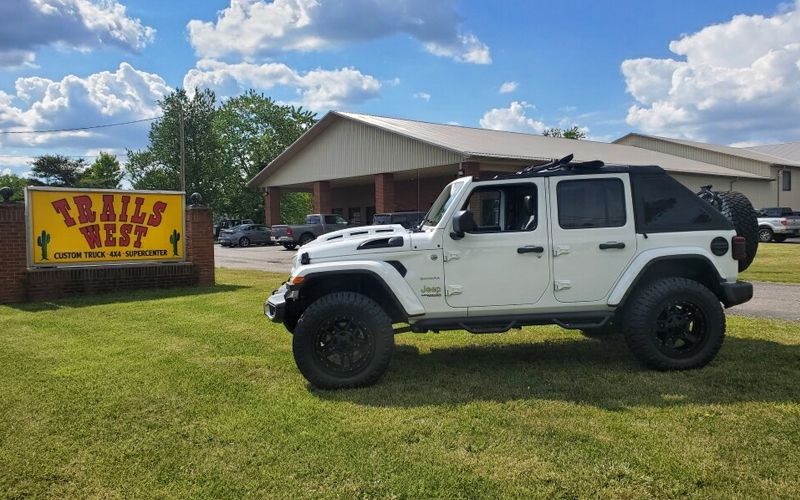 white jeep out front of Trails West