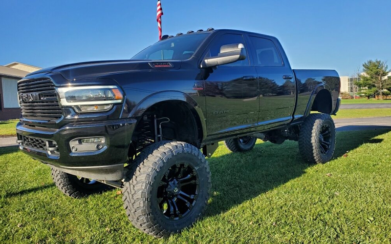 black lifted truck on grass